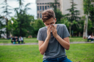 a person suffering from hay fever, in an urban park