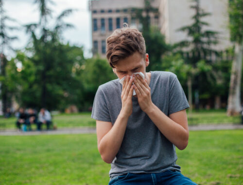 a person suffering from hay fever, in an urban park