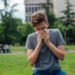 a person suffering from hay fever, in an urban park